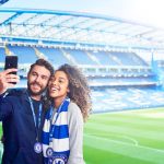 couple taking a selfie in front of pitch